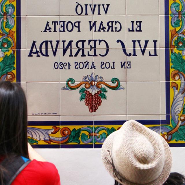 Students read a Spanish tile sign
